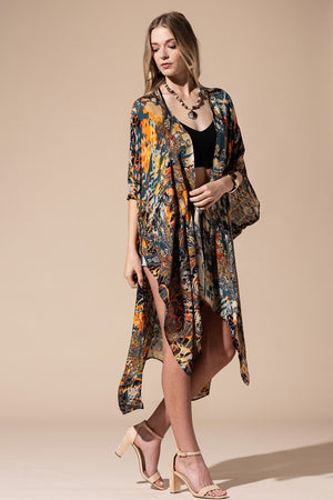 woman wearing a Lightweight Kimono
in a Mixed Paisley Pattern Print of deep teal blue, orange and beige colors, open front with slide slit. 
