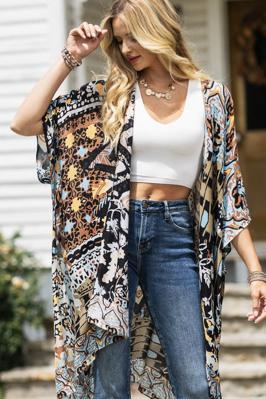 woman wearing Lightweight Kimono
in shades of black, brown, light blue, gold in an Abstract Pattern 
Open Front
Side Slit