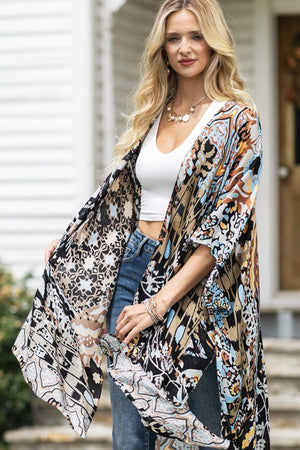 woman wearing Lightweight Kimono
in shades of black, brown, light blue, gold in an Abstract Pattern 
Open Front
Side Slit