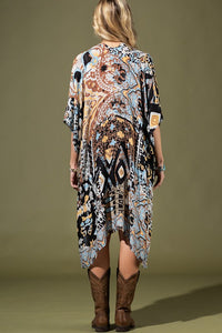 woman wearing Lightweight Kimono
in shades of black, brown, light blue, gold in an Abstract Pattern 
Open Front
Side Slit