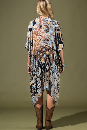 woman wearing Lightweight Kimono
in shades of black, brown, light blue, gold in an Abstract Pattern 
Open Front
Side Slit