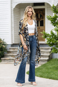 woman wearing Lightweight Kimono
in shades of black, brown, light blue, gold in an Abstract Pattern 
Open Front
Side Slit