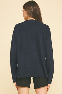 female wearing a V-Neck Navy Pullover with long sleeves and ribbed cuffs and hem