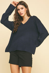 female wearing a V-Neck Navy Pullover with long sleeves and ribbed cuffs and hem