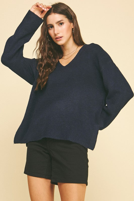 female wearing a V-Neck Navy Pullover with long sleeves and ribbed cuffs and hem