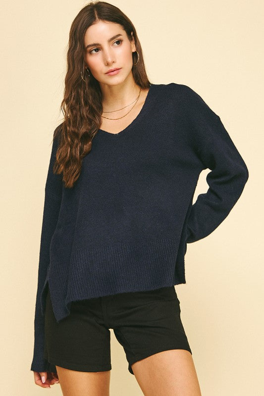 female wearing a V-Neck Navy Pullover with long sleeves and ribbed cuffs and hem
