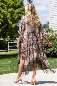 woman wearing Lightweight Kimono
Mixed Paisley Pattern Print in shades of beige, orange, blues
Long Fringe at the Bottom
Open Front
Side Slits