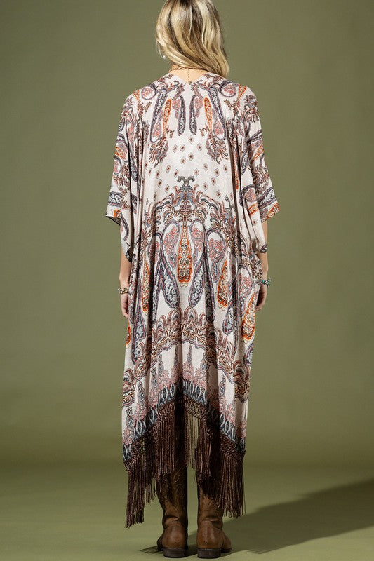 back of woman wearing Lightweight Kimono
Mixed Paisley Pattern Print in shades of beige, orange, blues
Long Fringe at the Bottom
Open Front
Side Slits