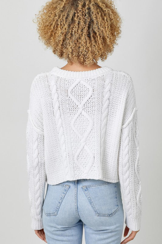 WHITE CABLE KNIT SWEATER WITH RAW EDGE HEM, ROUND NECKLINE, LONG SLEEVES