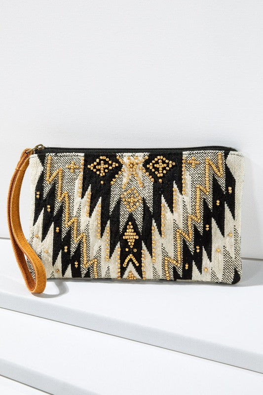 "Wren" Ethnic Pattern Wristlet in shades of Black/Gold/Natural with gold seed beading and zipper closure