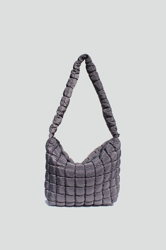 Gray nylon quilted crossbody bag with adjustable drawstring strap, zipper closure and interior wall pockets. 