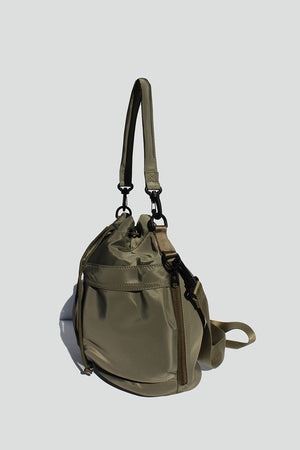 Army Green nylon bucket bag with  drawstring closure, two detachable strap options (long strap, short handle) with exterior pockets in front.