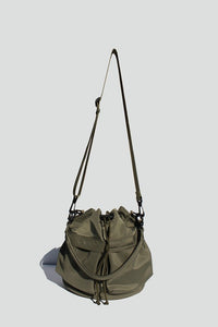 Army Green nylon bucket bag with  drawstring closure, two detachable strap options (long strap, short handle) with exterior pockets in front.