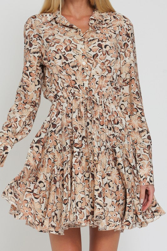 LONG SLEEVED FLORAL FLIRTY SKIRT MINI DRESS IN A FLORAL PRETTY IN SHADES OF BROWN AND BEIGE.  DRAWSTRING TIE AT WAIST.