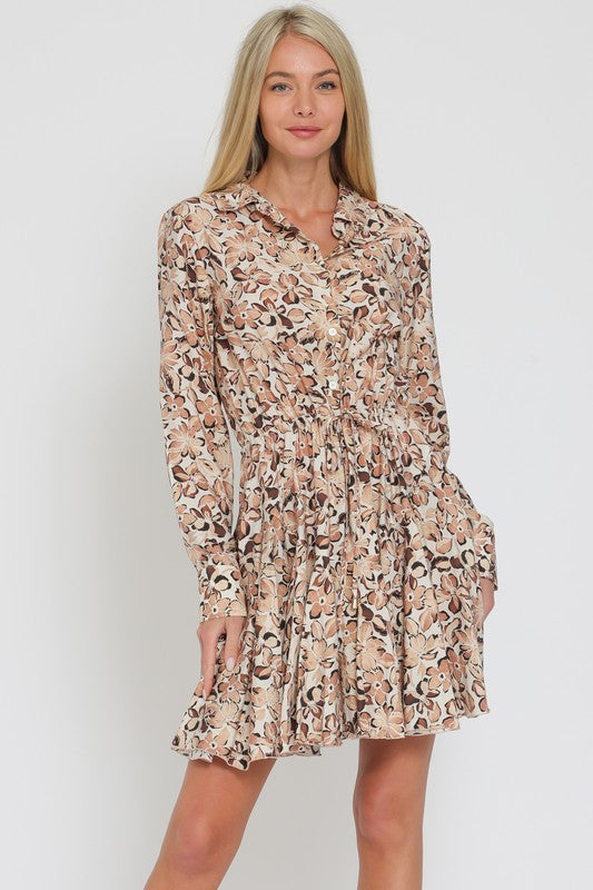 LONG SLEEVED FLORAL FLIRTY SKIRT MINI DRESS IN A FLORAL PRETTY IN SHADES OF BROWN AND BEIGE.  DRAWSTRING TIE AT WAIST.