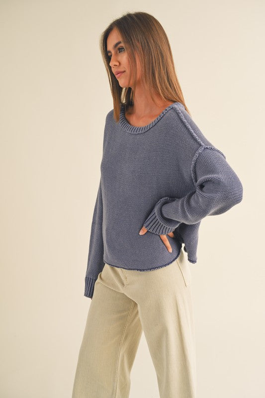 dye wash pull over sweater in denim blue with round crew neck, long sleeves, drop shoulders with exposed seams