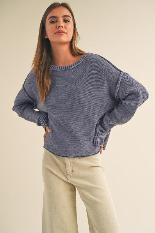 dye wash pull over sweater in denim blue with round crew neck, long sleeves, drop shoulders with exposed seams