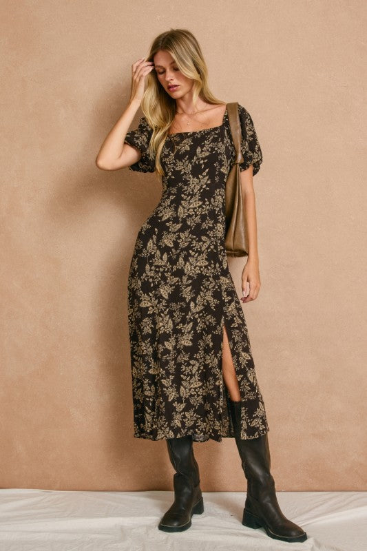 High slit midi dress with square neckline and elasticized sleeves that can be worn on or off the shoulder.  In dark brown with a cream floral print.