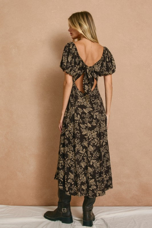 High slit midi dress with square neckline and elasticized sleeves that can be worn on or off the shoulder.  In dark brown with a cream floral print.