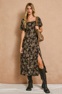 High slit midi dress with square neckline and elasticized sleeves that can be worn on or off the shoulder.  In dark brown with a cream floral print.