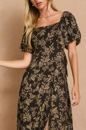 High slit midi dress with square neckline and elasticized sleeves that can be worn on or off the shoulder.  In dark brown with a cream floral print.