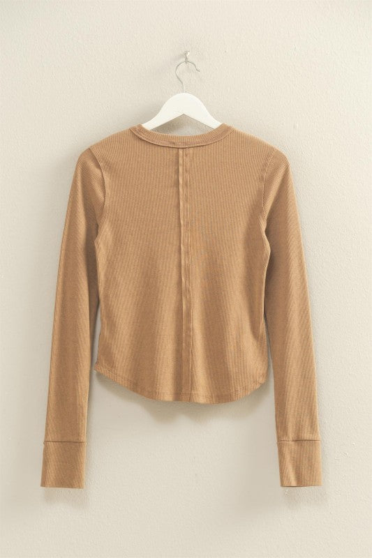 mineral washed taupe colored t-shirt with thumb hole long sleeves and reversed stitching around collar and shoulders, exposed seam down the back