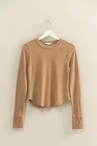 mineral washed taupe colored t-shirt with thumb hole long sleeves and reversed stitching around collar and shoulders, exposed seam down the back