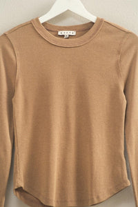 mineral washed taupe colored t-shirt with thumb hole long sleeves and reversed stitching around collar and shoulders, exposed seam down the back