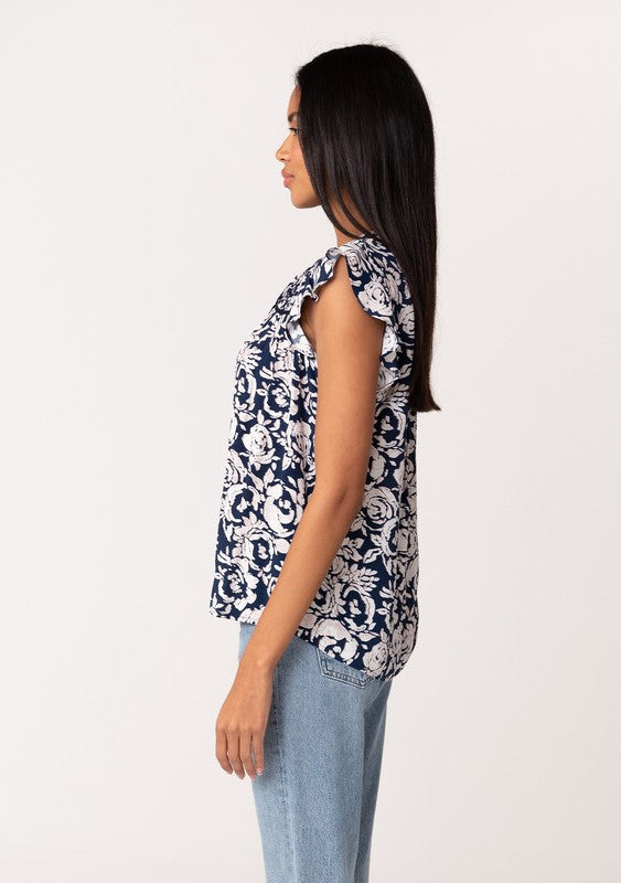 FLUTTER SLEEVE BLOUSE IN A NAVY AND NATURAL COLOR PRINT WITH SPLIT V NECKLINE AND TASSEL TIES