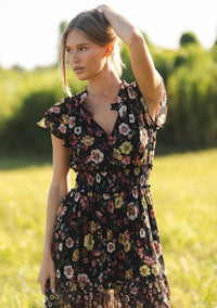 floral print maxi dress with front slit, ruffle short sleeves, contrast floral print on bottom, V-neck, smocked waist band, color is black with rose, ivory and green flower print. 