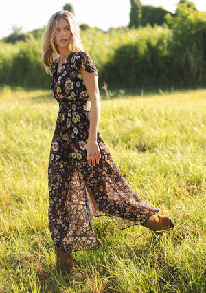 floral print maxi dress with front slit, ruffle short sleeves, contrast floral print on bottom, V-neck, smocked waist band, color is black with rose, ivory and green flower print. 