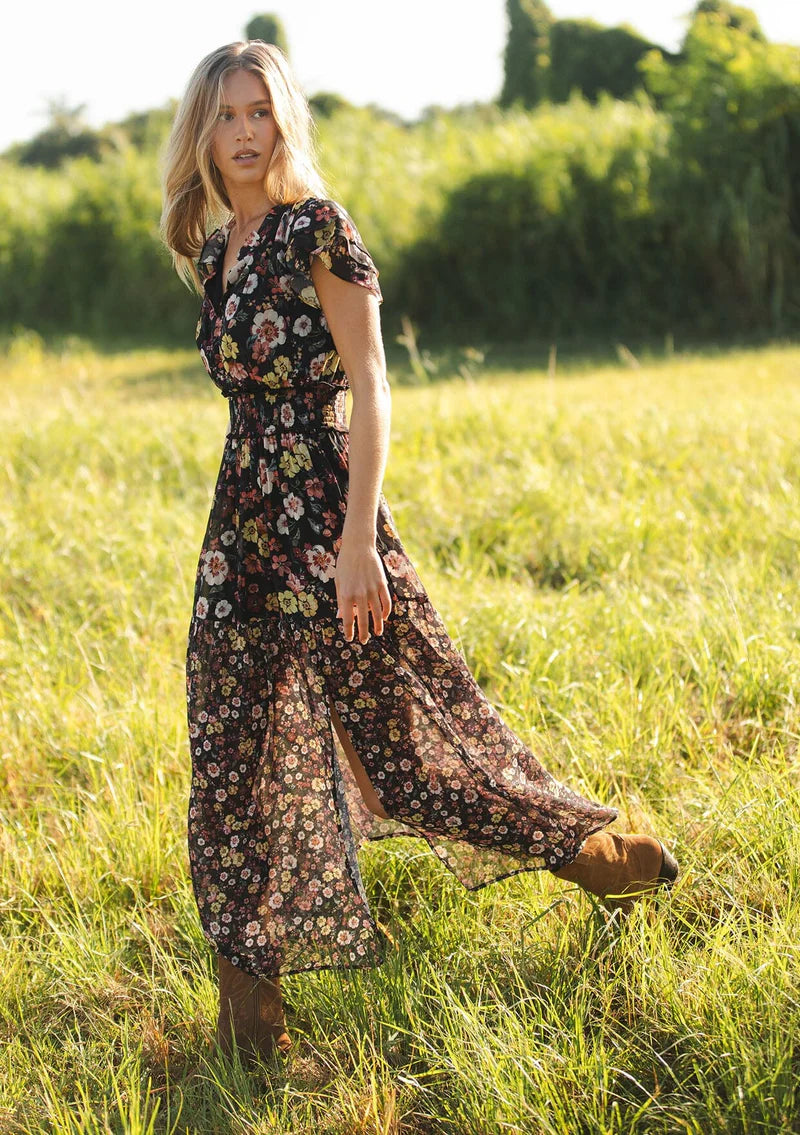 floral print maxi dress with front slit, ruffle short sleeves, contrast floral print on bottom, V-neck, smocked waist band, color is black with rose, ivory and green flower print. 