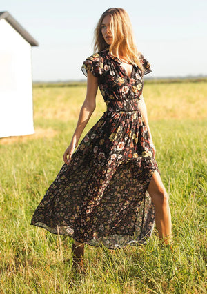 floral print maxi dress with front slit, ruffle short sleeves, contrast floral print on bottom, V-neck, smocked waist band, color is black with rose, ivory and green flower print. 
