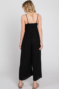 black gauze jumpsuit with side pockets, front tie key-hole, just above ankle length, and spaghetti straps