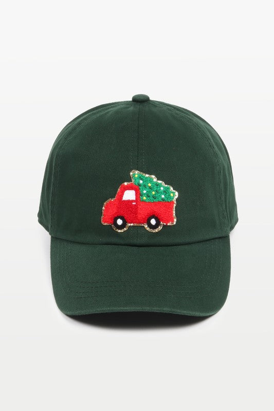 Baseball cap with a chenille patch depicting an adorned Christmas Tree in a Vintage Truck in dark green