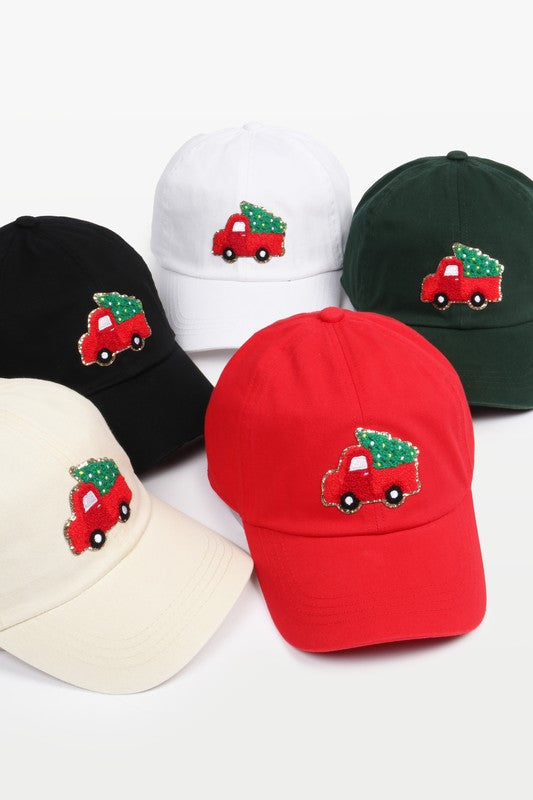 Baseball caps with a chenille patch depicting an adorned Christmas Tree in a Vintage Truck 