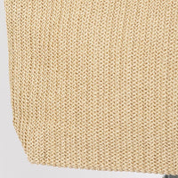 Close-up of beige knitted fabric on a light gray background