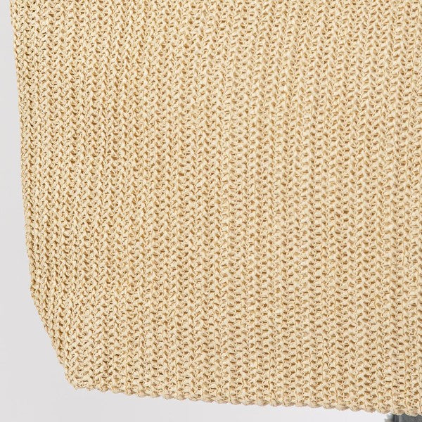 Close-up of beige knitted fabric on a light gray background