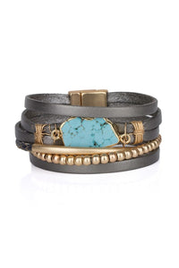stackable leather wrapped bracelet with gold-tone beads and bar with a turquoise center piece and gold-tone magnetic clasp 