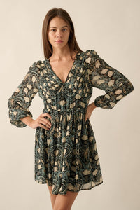 Lined v-neck mini dress in a black floral print with shades of cream, tan and sage