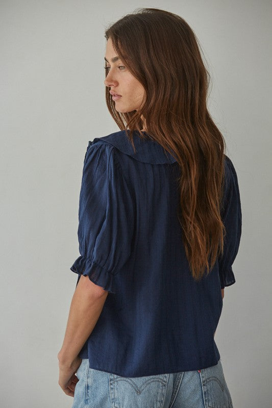 back view of 100% Cotton, Navy V-neck, ruffle detail top with 1/2 sleeve length and elastic ruffle band