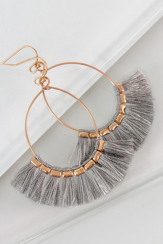 Fish hook style earrings in gold with gray fine thread tassels