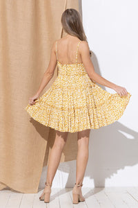 FLORAL MINI WITH FLARED SKIRT in a gold floral print with adjustable spaghetti straps and a flared tiered ruffle skirt