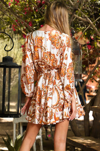 Surplice Bodice Mini Dress Dolman Sleeves 3/4 Length Sleeves with Elastic Cuffs V-Neckline with Snap Closure Braided Belt, Elastic Waist Ruffle Flared Hemline Unlined, Not Sheer Color:  White with Orange/Gold/Lavender Floral Print