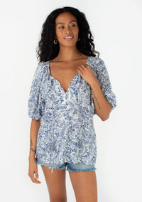 BLUE FLORAL PUFF SLEEVE PEASANT TOP WITH VNECK AND THREE QUARTER BUTTON UP FRONT WITH TASSLE TIES