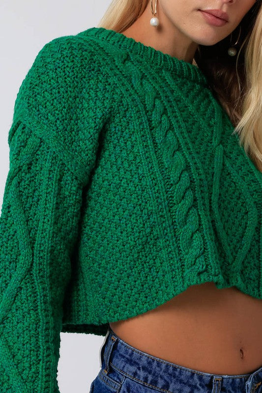 Green cable knit sweater with cropped length and drop shoulders