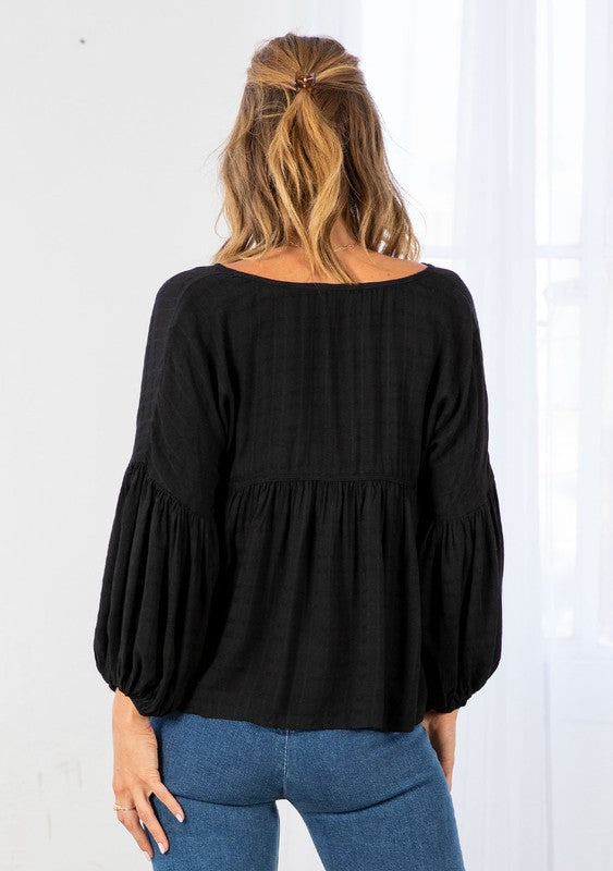 Bohemian Style Peasant Top with 3/4 Length Balloon Sleeves, Elastic Band at Wrists, Relaxed Fit that is Slightly Cropped Length and a Split V-Neckline with Tassel Ties. Shirring Details Throughout Unlined, Not Sheer Color:  Black  Fabric: 100% Rayon 