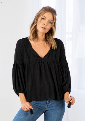 Bohemian Style Peasant Top with 3/4 Length Balloon Sleeves, Elastic Band at Wrists, Relaxed Fit that is Slightly Cropped Length and a Split V-Neckline with Tassel Ties. Shirring Details Throughout Unlined, Not Sheer Color:  Black  Fabric: 100% Rayon 