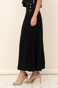 Linen blend maxi skirt in black with functional faux wooden buttons at side waist.  Hidden side pockets.
