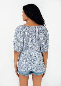 BLUE FLORAL PUFF SLEEVE PEASANT TOP WITH VNECK AND THREE QUARTER BUTTON UP FRONT WITH TASSLE TIES